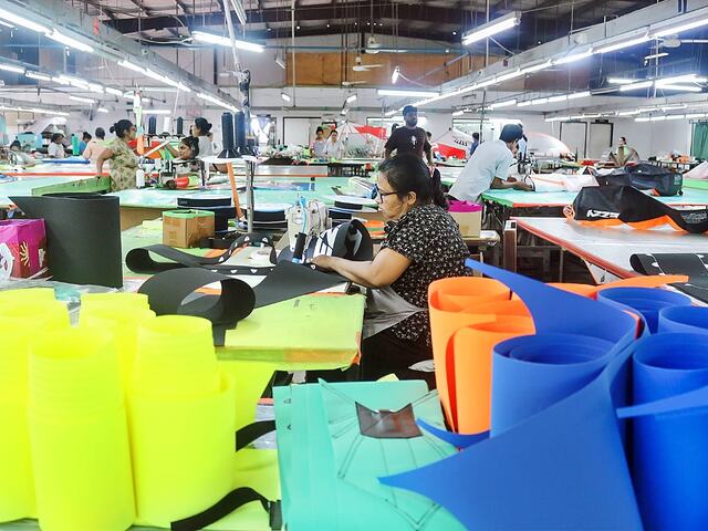 Sewing harness and bag components at the Ezzy factory