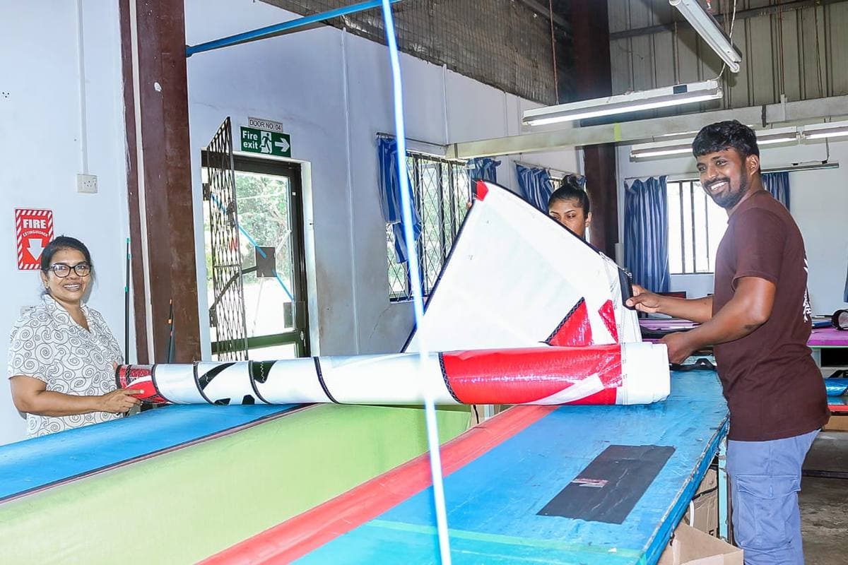 Ezzy Sails Lanka staff rolling a finished sail together